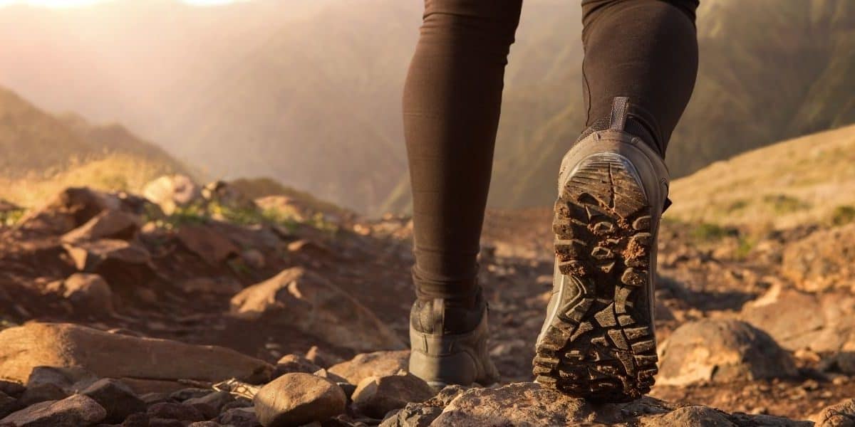 close up of a hiker's shoe covered in dirt on a mountain