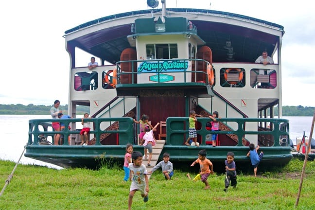 Small Cruise Ships Go Where Big Cruise Ships Can't --village children jump off the back of our amazon river boat.