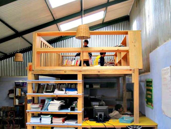 The English classroom with a second-floor, indoor library addition (Earthbag wall in the back of the photo and existing staircase wall to the right